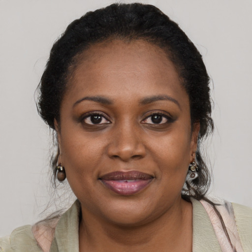 Joyful black young-adult female with medium  black hair and brown eyes