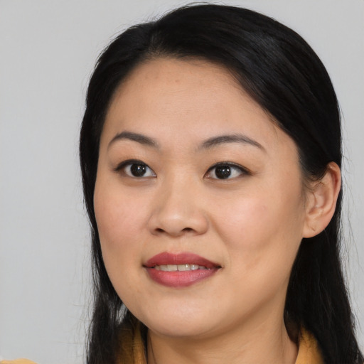 Joyful asian young-adult female with long  black hair and brown eyes