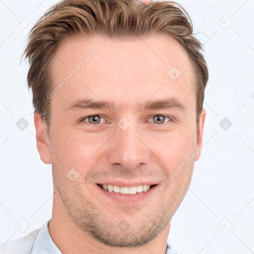 Joyful white young-adult male with short  brown hair and blue eyes