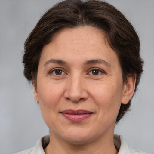 Joyful white adult female with medium  brown hair and brown eyes