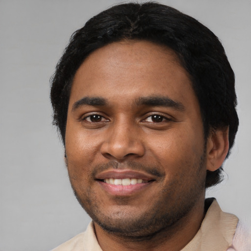 Joyful black young-adult male with short  black hair and brown eyes