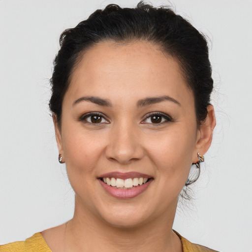 Joyful latino young-adult female with short  brown hair and brown eyes