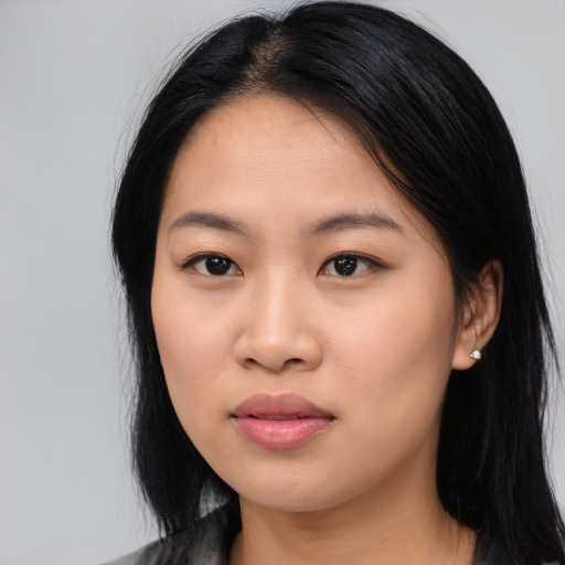 Joyful asian young-adult female with long  black hair and brown eyes