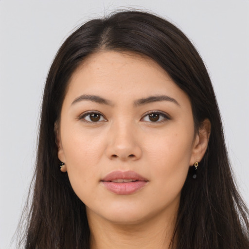 Joyful asian young-adult female with long  brown hair and brown eyes