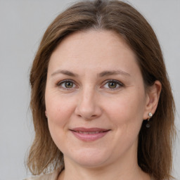 Joyful white adult female with medium  brown hair and grey eyes