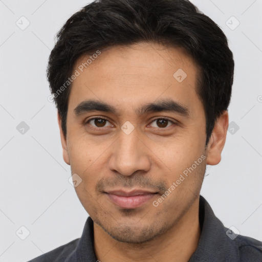 Joyful asian young-adult male with short  black hair and brown eyes