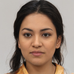 Joyful latino young-adult female with medium  brown hair and brown eyes