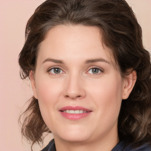 Joyful white young-adult female with medium  brown hair and green eyes