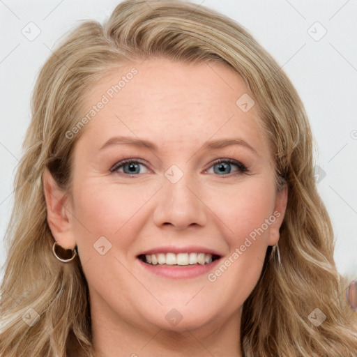 Joyful white young-adult female with long  brown hair and blue eyes