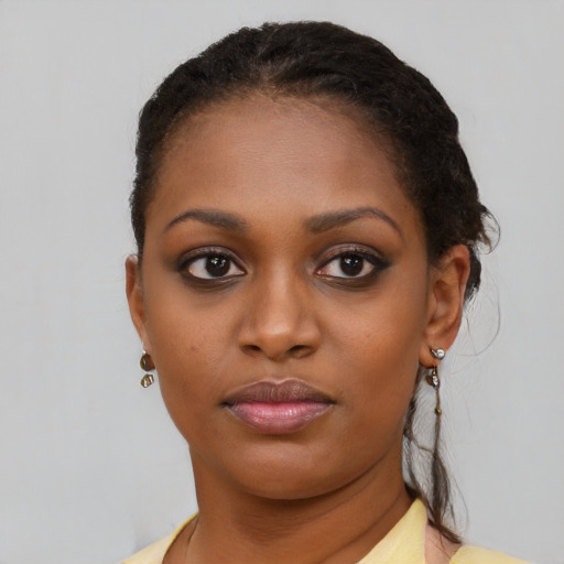 Joyful black young-adult female with short  brown hair and brown eyes