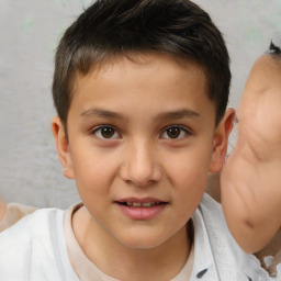 Joyful white child male with short  brown hair and brown eyes