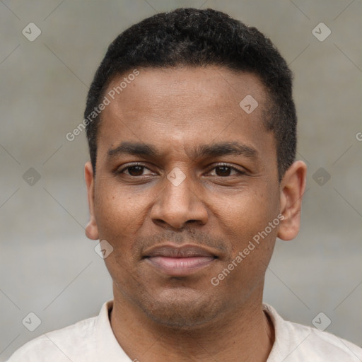 Joyful latino young-adult male with short  brown hair and brown eyes