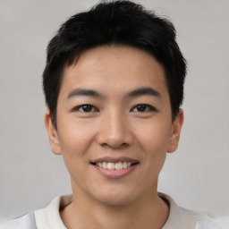 Joyful asian young-adult male with short  black hair and brown eyes