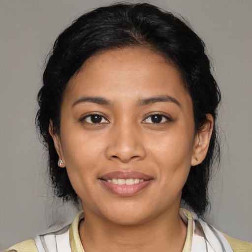 Joyful latino young-adult female with medium  black hair and brown eyes