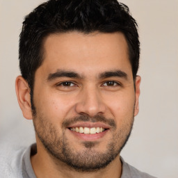 Joyful white young-adult male with short  black hair and brown eyes