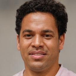 Joyful latino adult male with short  brown hair and brown eyes