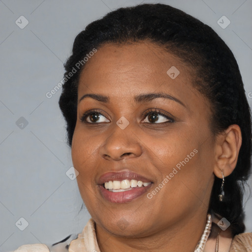 Joyful black adult female with short  black hair and brown eyes