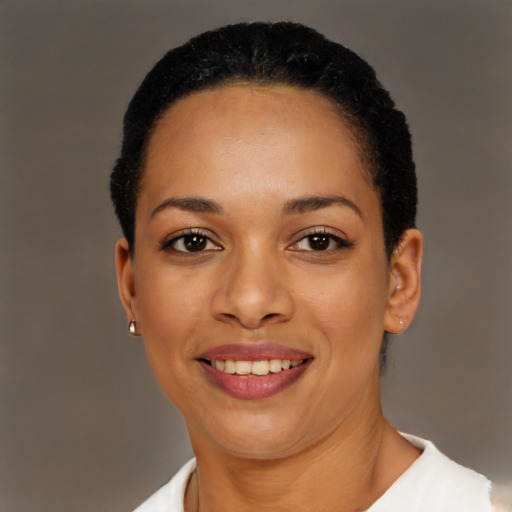 Joyful black young-adult female with short  black hair and brown eyes