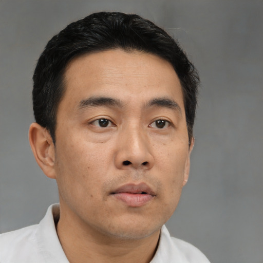 Neutral asian adult male with short  brown hair and brown eyes