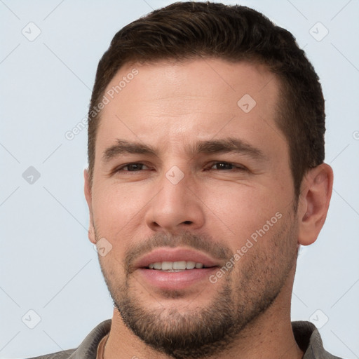 Joyful white young-adult male with short  brown hair and brown eyes