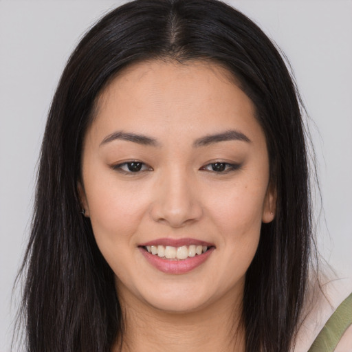 Joyful asian young-adult female with long  brown hair and brown eyes
