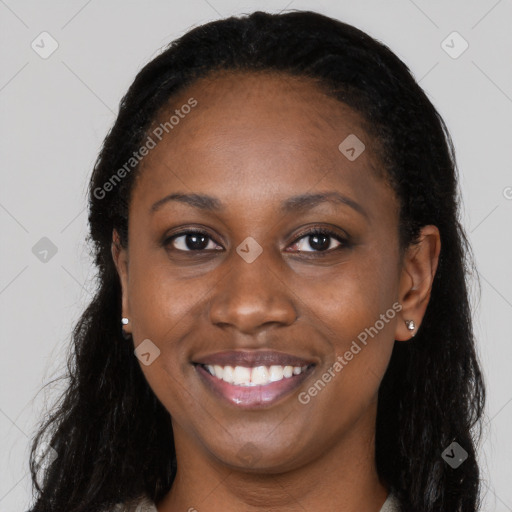 Joyful black young-adult female with long  brown hair and brown eyes