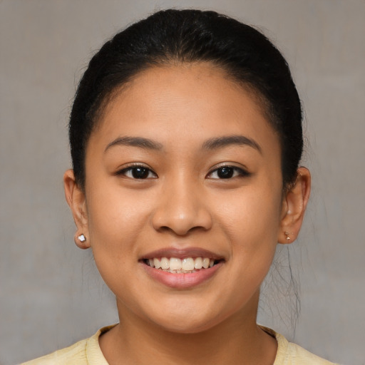 Joyful latino young-adult female with short  brown hair and brown eyes