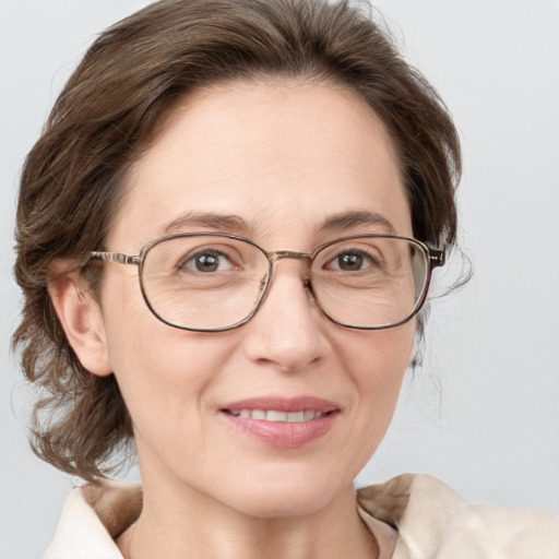 Joyful white adult female with medium  brown hair and blue eyes