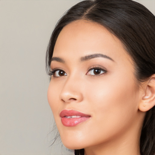 Joyful white young-adult female with long  black hair and brown eyes