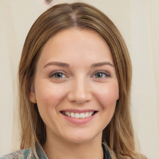 Joyful white young-adult female with medium  brown hair and green eyes