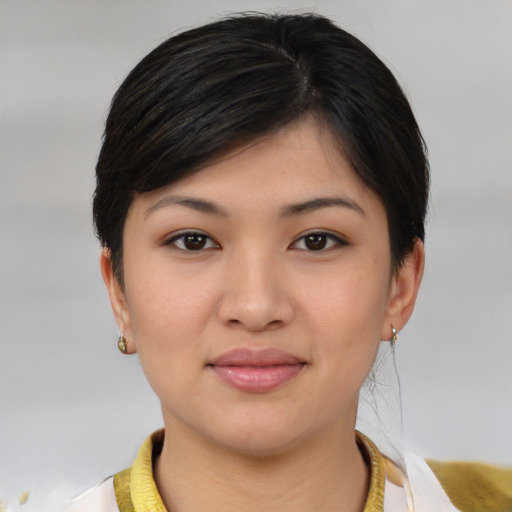Joyful asian young-adult female with short  brown hair and brown eyes