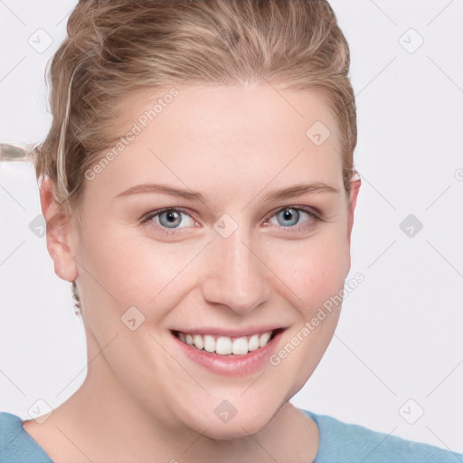 Joyful white young-adult female with short  brown hair and blue eyes