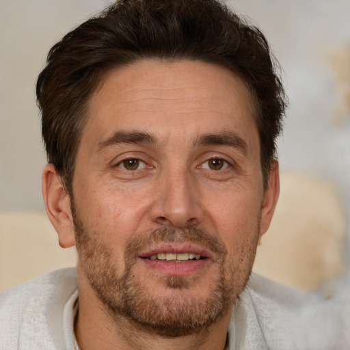 Joyful white adult male with short  brown hair and brown eyes