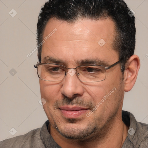 Joyful white adult male with short  black hair and brown eyes