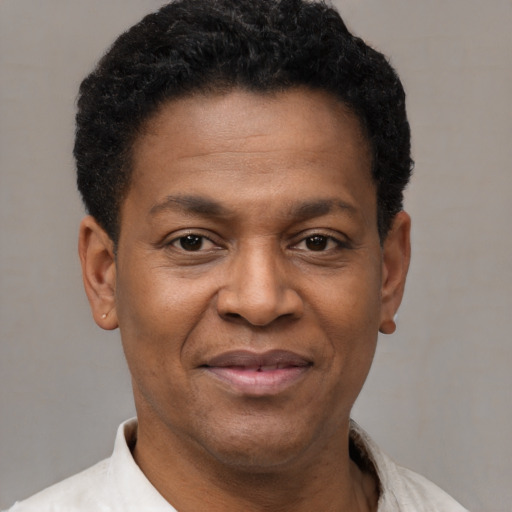 Joyful latino adult male with short  black hair and brown eyes