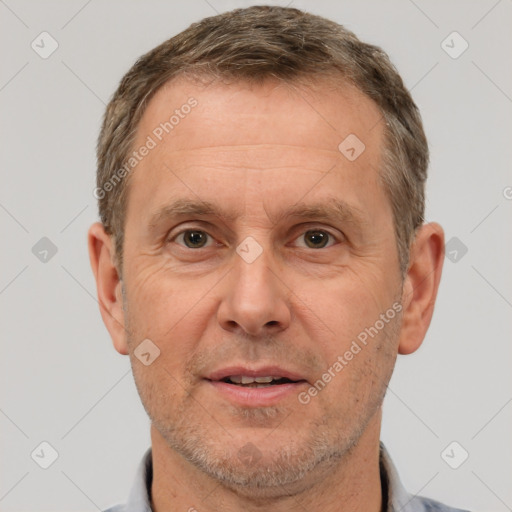 Joyful white adult male with short  brown hair and brown eyes