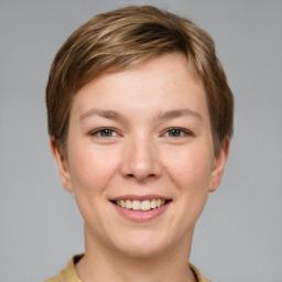 Joyful white young-adult female with short  brown hair and grey eyes