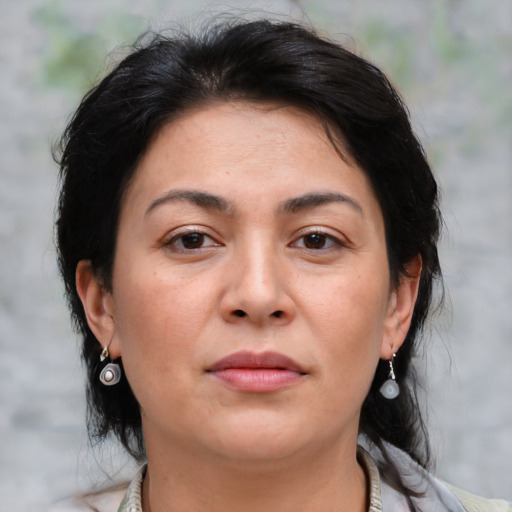 Joyful asian adult female with medium  brown hair and brown eyes