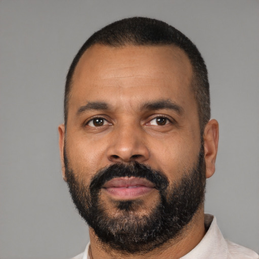 Neutral latino adult male with short  black hair and brown eyes