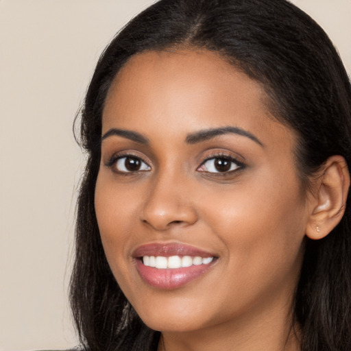 Joyful latino young-adult female with long  brown hair and brown eyes