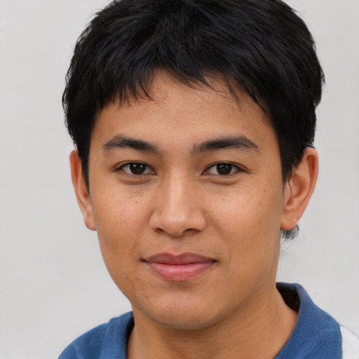 Joyful asian young-adult male with short  brown hair and brown eyes