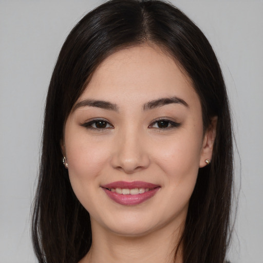 Joyful asian young-adult female with long  brown hair and brown eyes