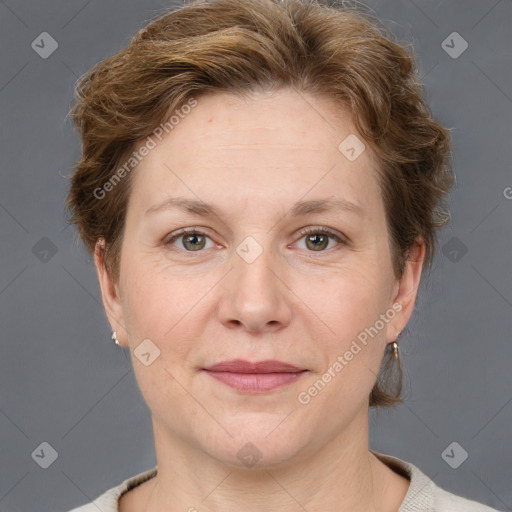 Joyful white adult female with short  brown hair and grey eyes