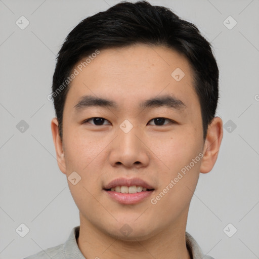 Joyful asian young-adult male with short  black hair and brown eyes