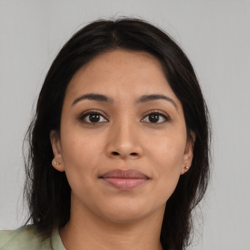 Joyful latino young-adult female with long  brown hair and brown eyes