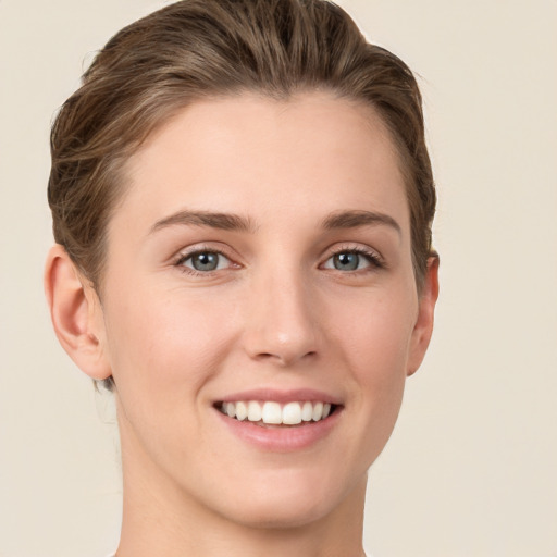 Joyful white young-adult female with short  brown hair and grey eyes