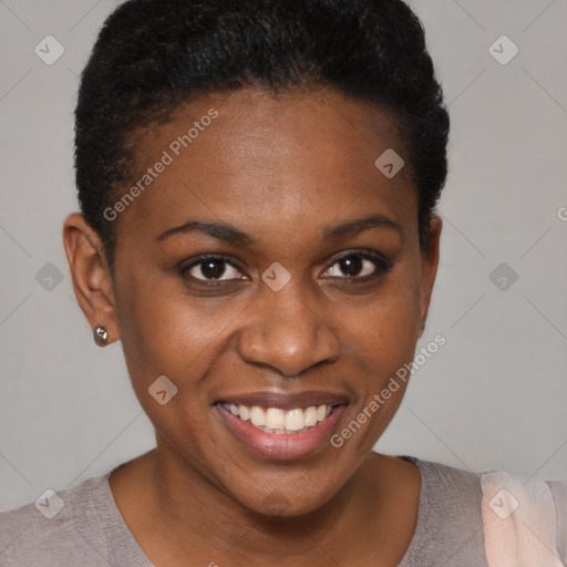 Joyful black young-adult female with short  brown hair and brown eyes