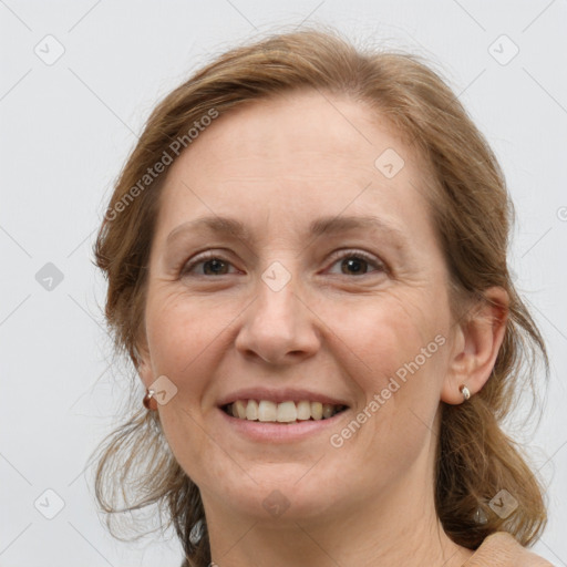 Joyful white adult female with medium  brown hair and grey eyes