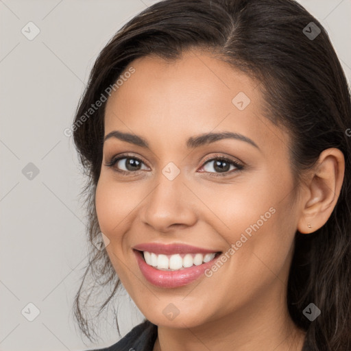 Joyful white young-adult female with long  brown hair and brown eyes