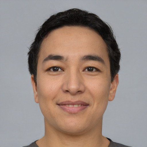 Joyful asian young-adult male with short  black hair and brown eyes